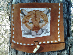 Cougar pattern design on leather pouch